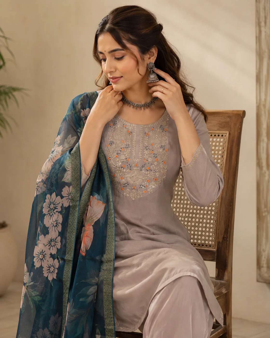 Woman wearing taupe grey embroidered 3 piece kurta set with matching trousers and teal floral organza dupatta — View 3